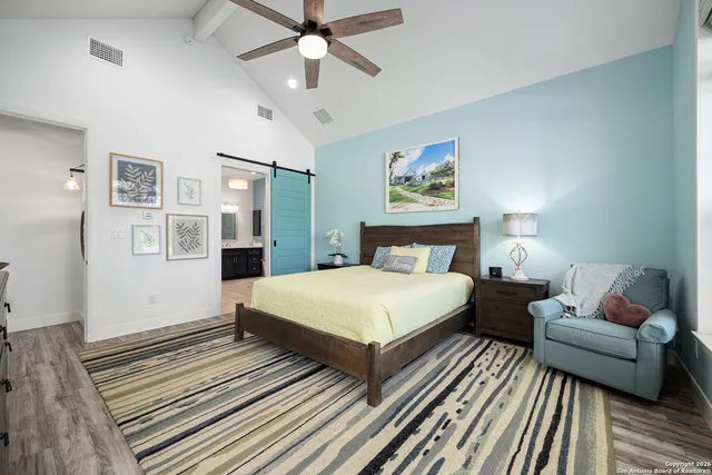 a bathroom with double vanity sinks and a large mirror