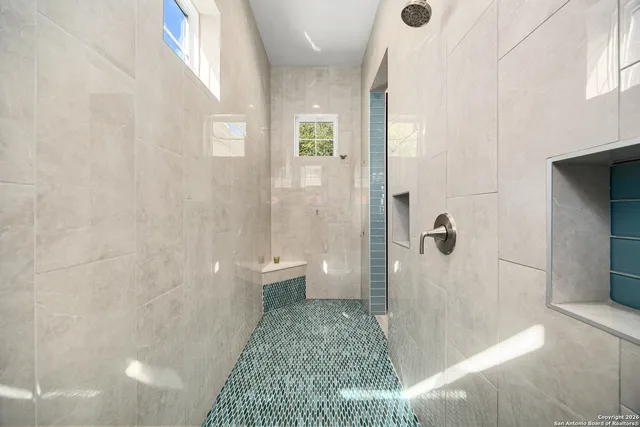 a bathroom with a sink a toilet and mirror