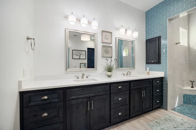 a large bed sitting in a bedroom next to a window with a dresser