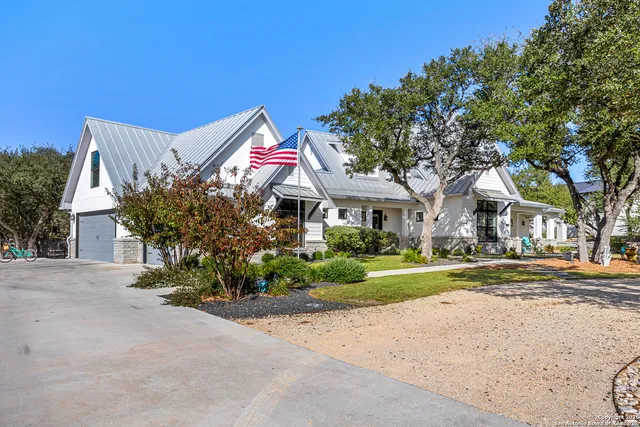 a front view of a house with a yard and a garage