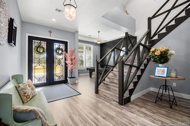 a living room with furniture and a floor to ceiling window