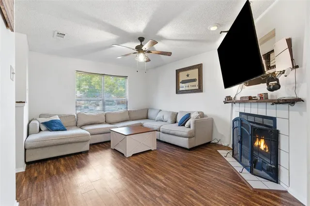 a living room with furniture a fireplace and a flat screen tv