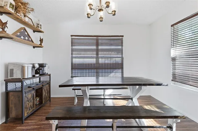 a kitchen with kitchen island granite countertop a stove and a microwave