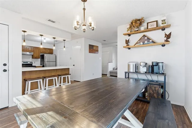 a view of a livingroom with furniture wooden floor and a chandelier