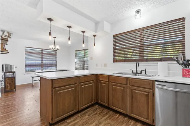 a kitchen with sink cabinets and wooden floor