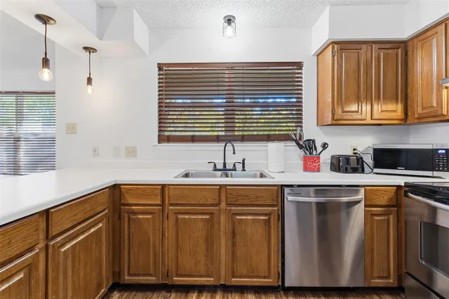 a kitchen with wooden cabinets and a sink