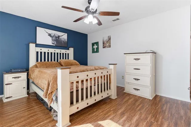 a bedroom with a bed and a dresser