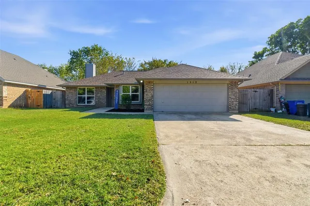 a front view of a house with yard and glass windows