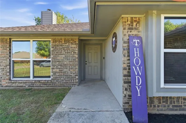 a front view of a house with a door and a window