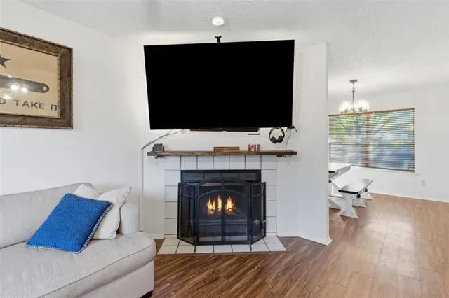 a living room with a fireplace a flat screen tv and a fireplace