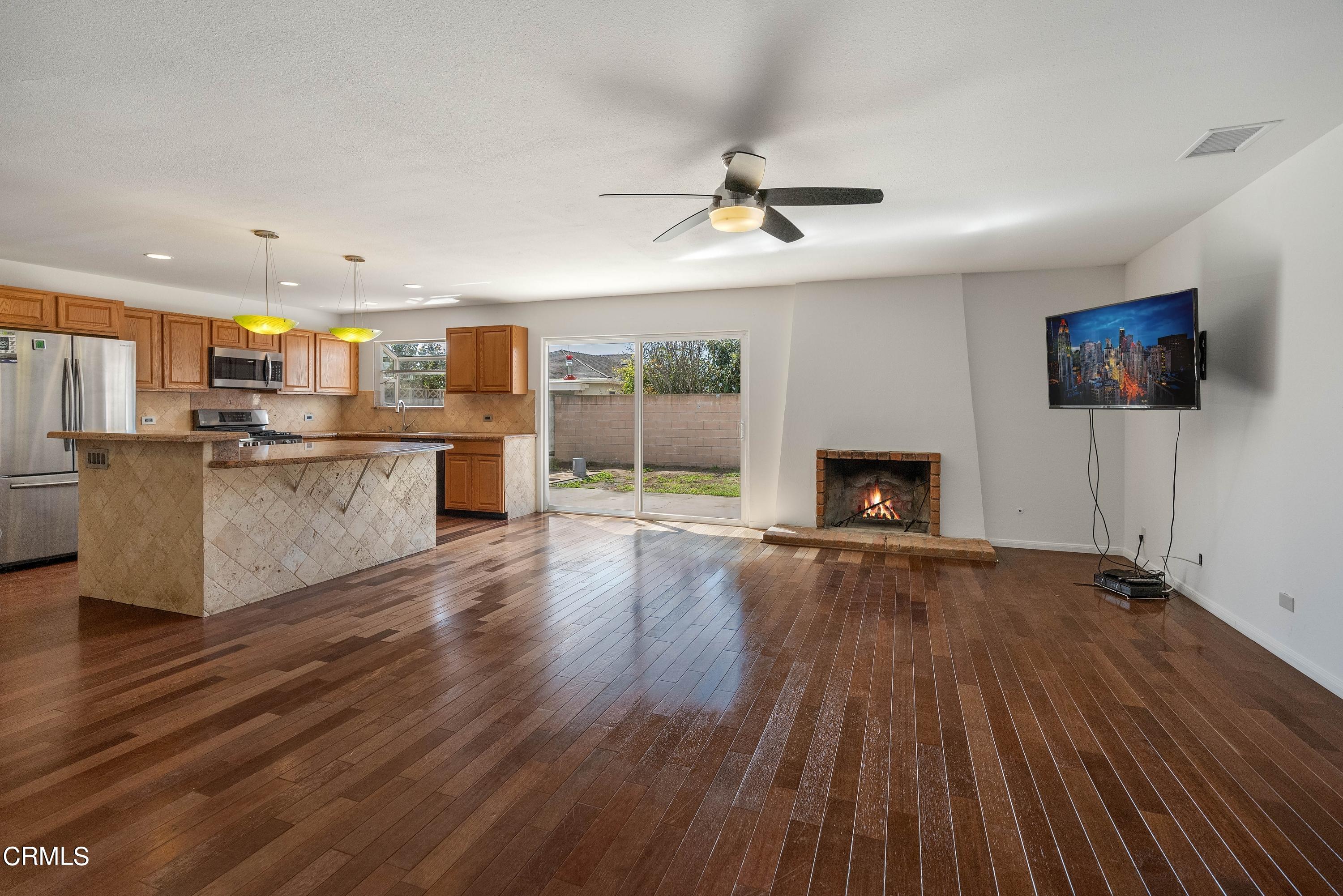 1121 Rachel Drive Oxnard, CA 93030 - Photo 5 of 21 a view of a kitchen with wooden floor and a fireplace
