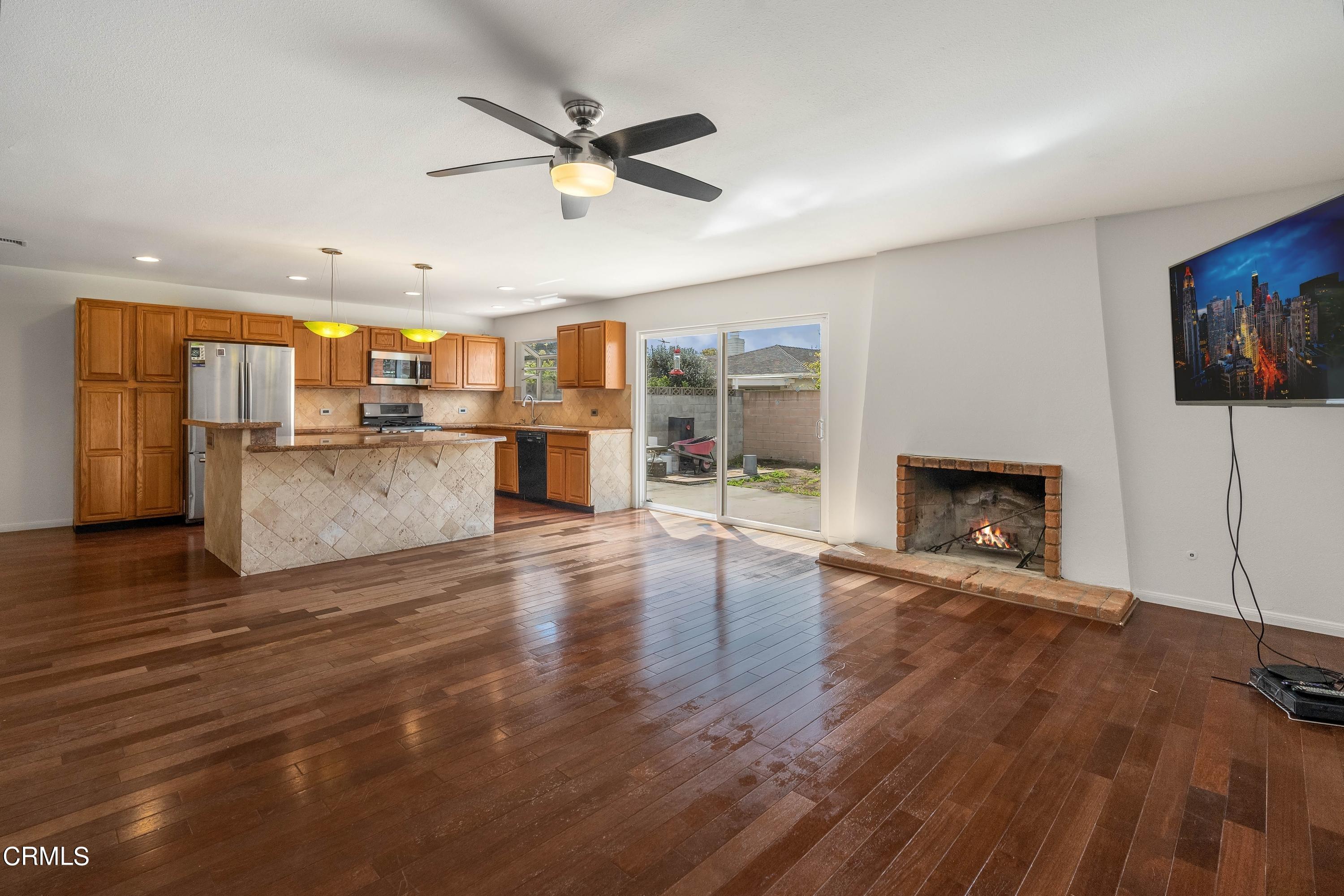 1121 Rachel Drive Oxnard, CA 93030 - Photo 6 of 21 an open kitchen with a table and a fireplace