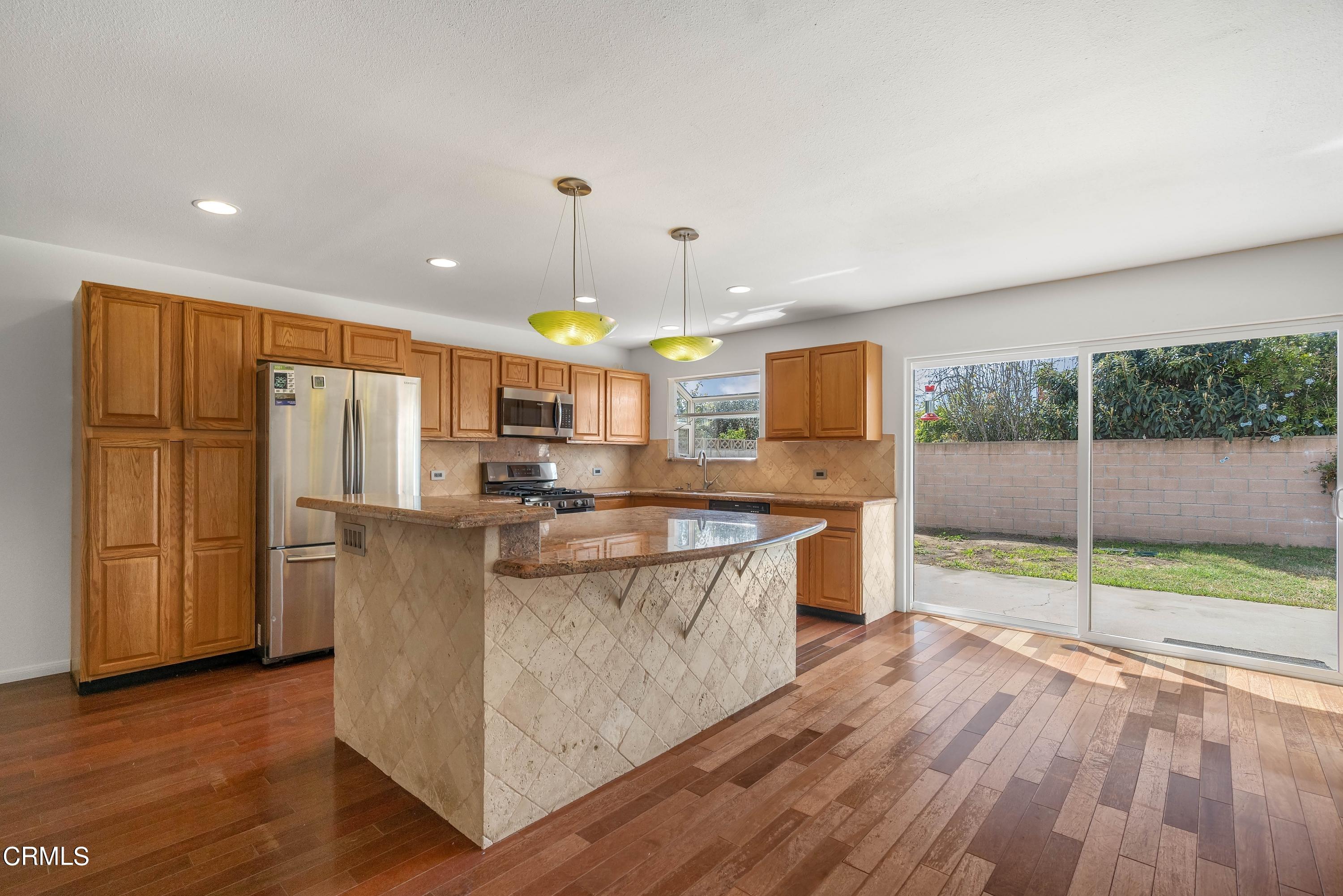 1121 Rachel Drive Oxnard, CA 93030 - Photo 7 of 21 a kitchen with stainless steel appliances granite countertop a refrigerator a stove top oven a sink and dishwasher