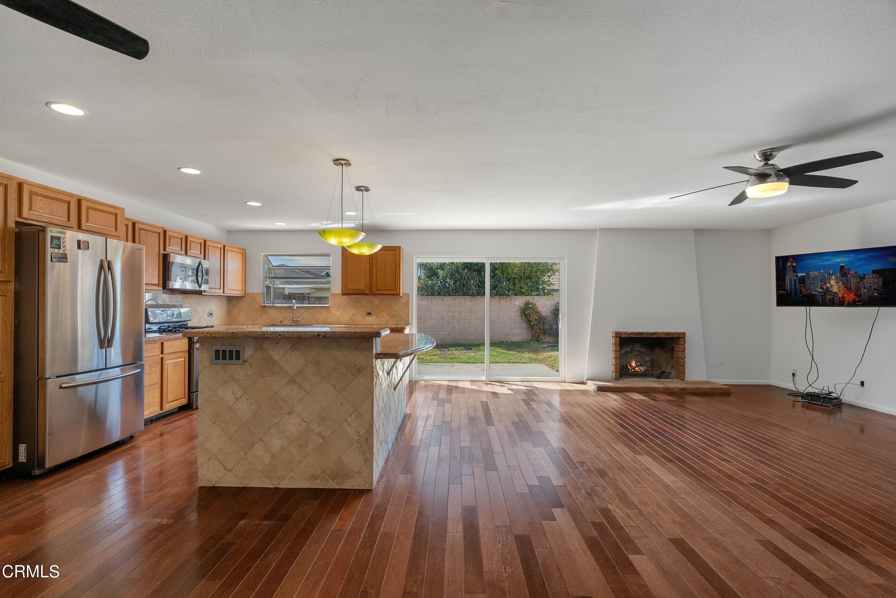 1121 Rachel Drive Oxnard, CA 93030 - Photo 9 of 21 a open kitchen with stainless steel appliances granite countertop a refrigerator oven a sink dishwasher and a stove with wooden floor