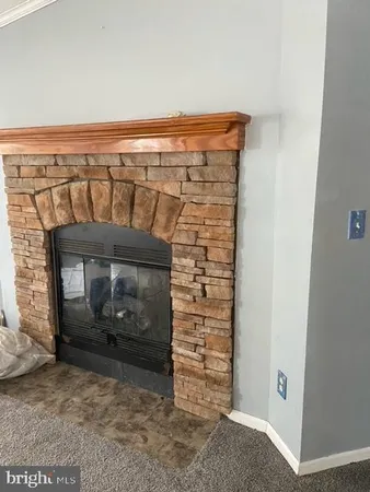 a view of a fireplace in an empty room