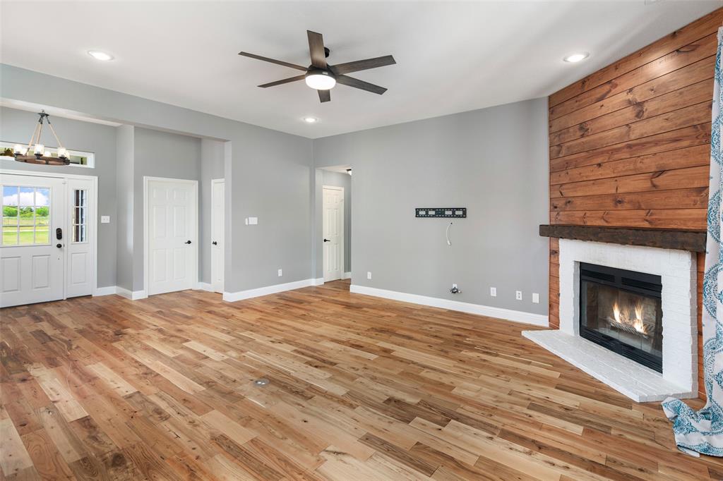 1019 Vaughan Lane Tioga, TX 76271 - Photo 15 of 40 Spacious living area featuring wood-finish flooring, a ceiling fan, and recessed lighting