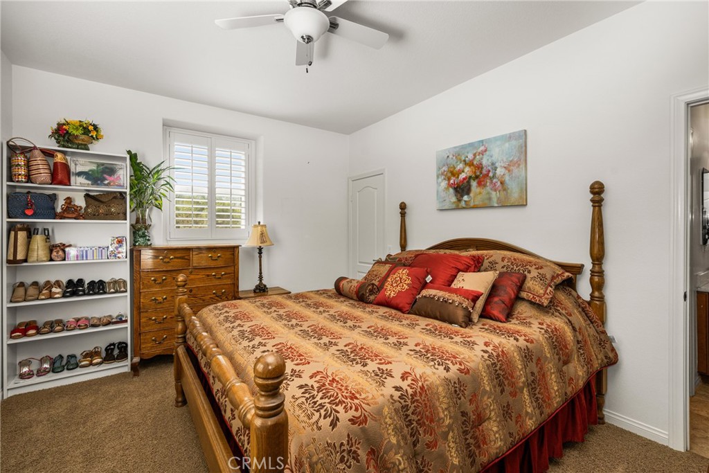 12652 Twin Peak Court Riverside, CA 92503 - Photo 30 of 55 a bedroom with a bed and a book shelf