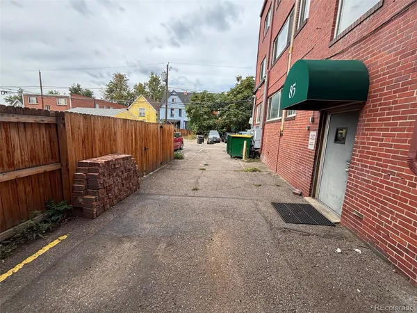 a view of a backyard with wooden fence