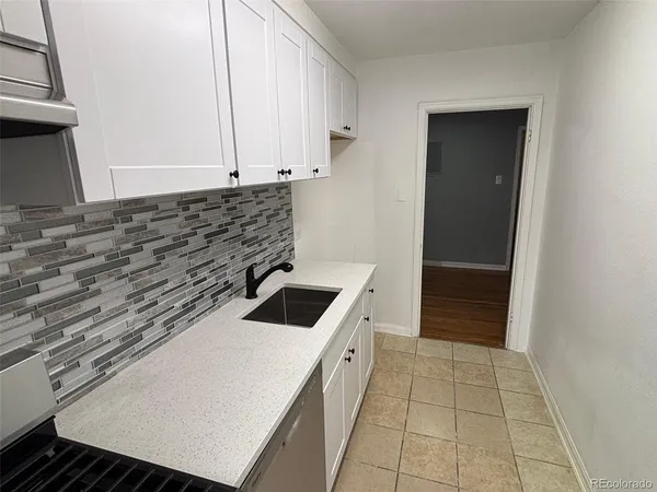 a kitchen with a stove and a sink