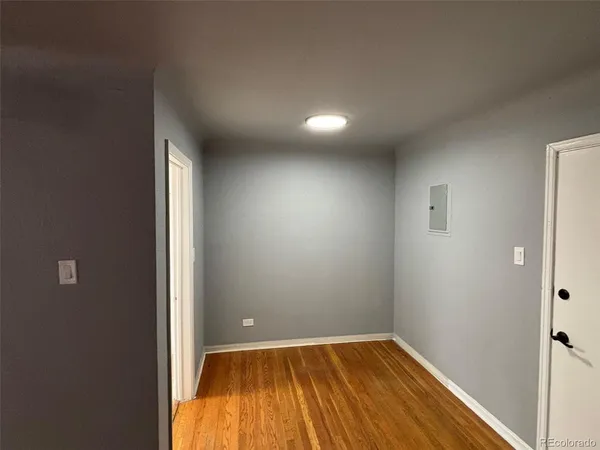 a view of room with window and wooden floor