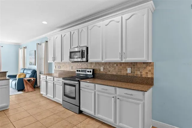 a kitchen with granite countertop a sink and cabinets