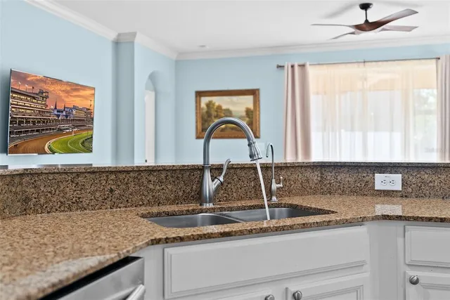 a view of a kitchen with kitchen island stainless steel appliances refrigerator sink and stove