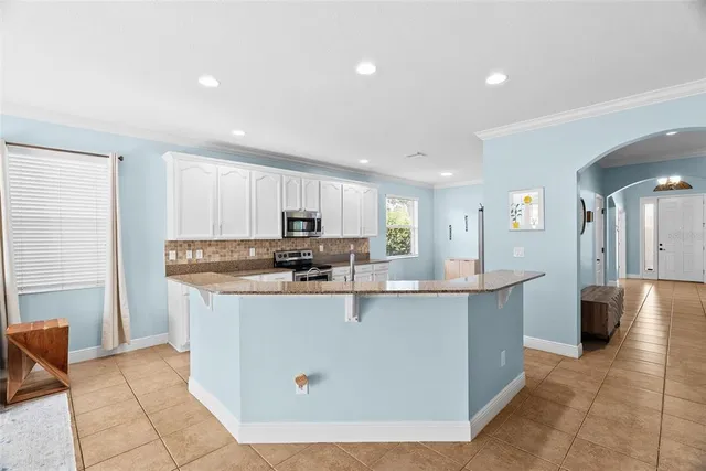 a living room with furniture and kitchen view