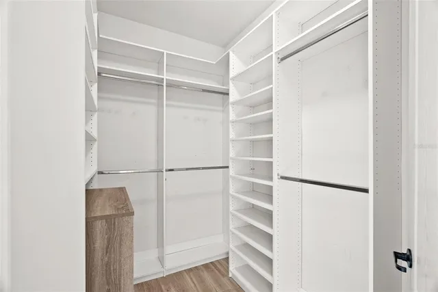 a bathroom with a granite countertop sink a mirror and a shower