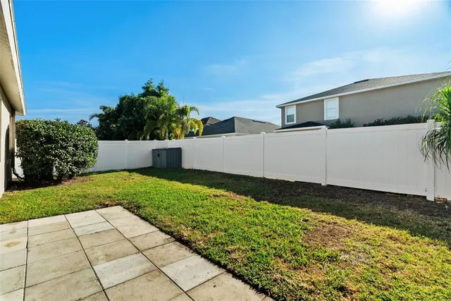 an aerial view of a house with a yard and a wooden fence