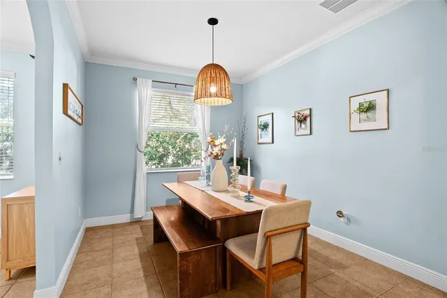 a dining room with a table and chairs