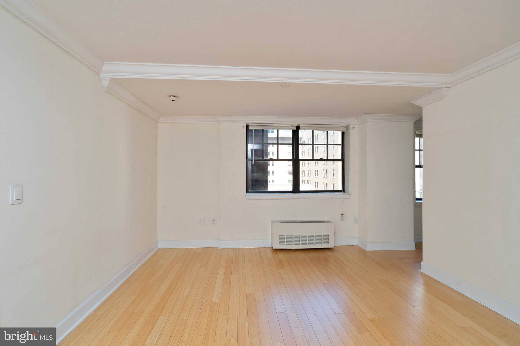 1701 Locust Street, Unit 1417 Philadelphia, PA 19103 - Photo 11 of 29 an empty room with wooden floor and windows