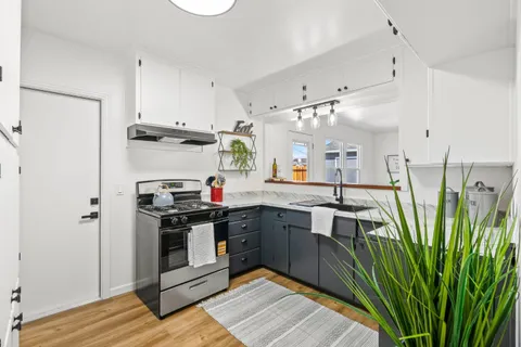 a kitchen with stainless steel appliances a stove a refrigerator and a sink