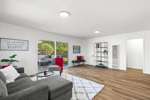 a living room with furniture window and wooden floor