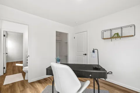 a view of a room with furniture and wooden floor
