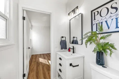 a bathroom with a sink a mirror and vanity