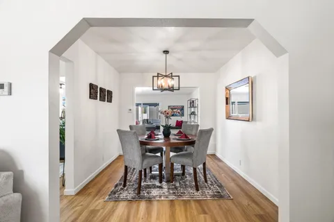 a view of a dining room with furniture and wooden floor
