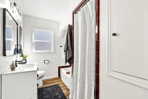 a bathroom with a sink a mirror and a shower
