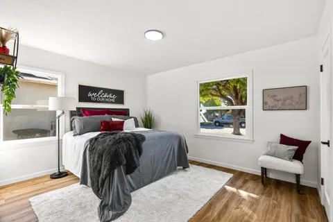 a bed room with a bed and a chair