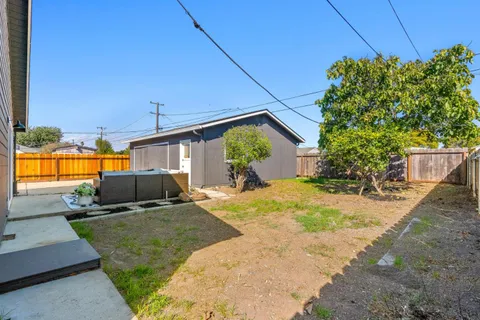 an aerial view of a house with a garden and trees