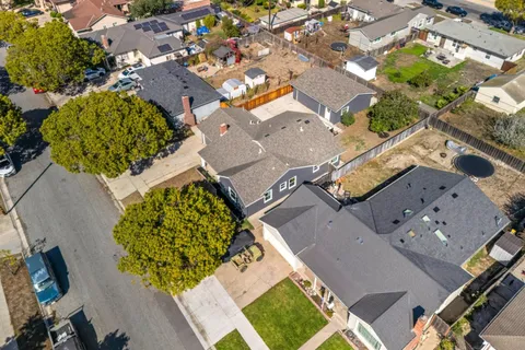 an aerial view of a house with a yard