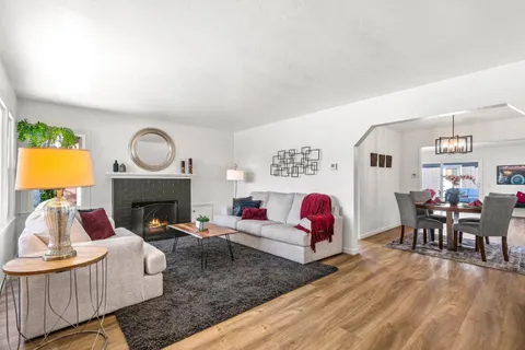 a living room with furniture fireplace and window