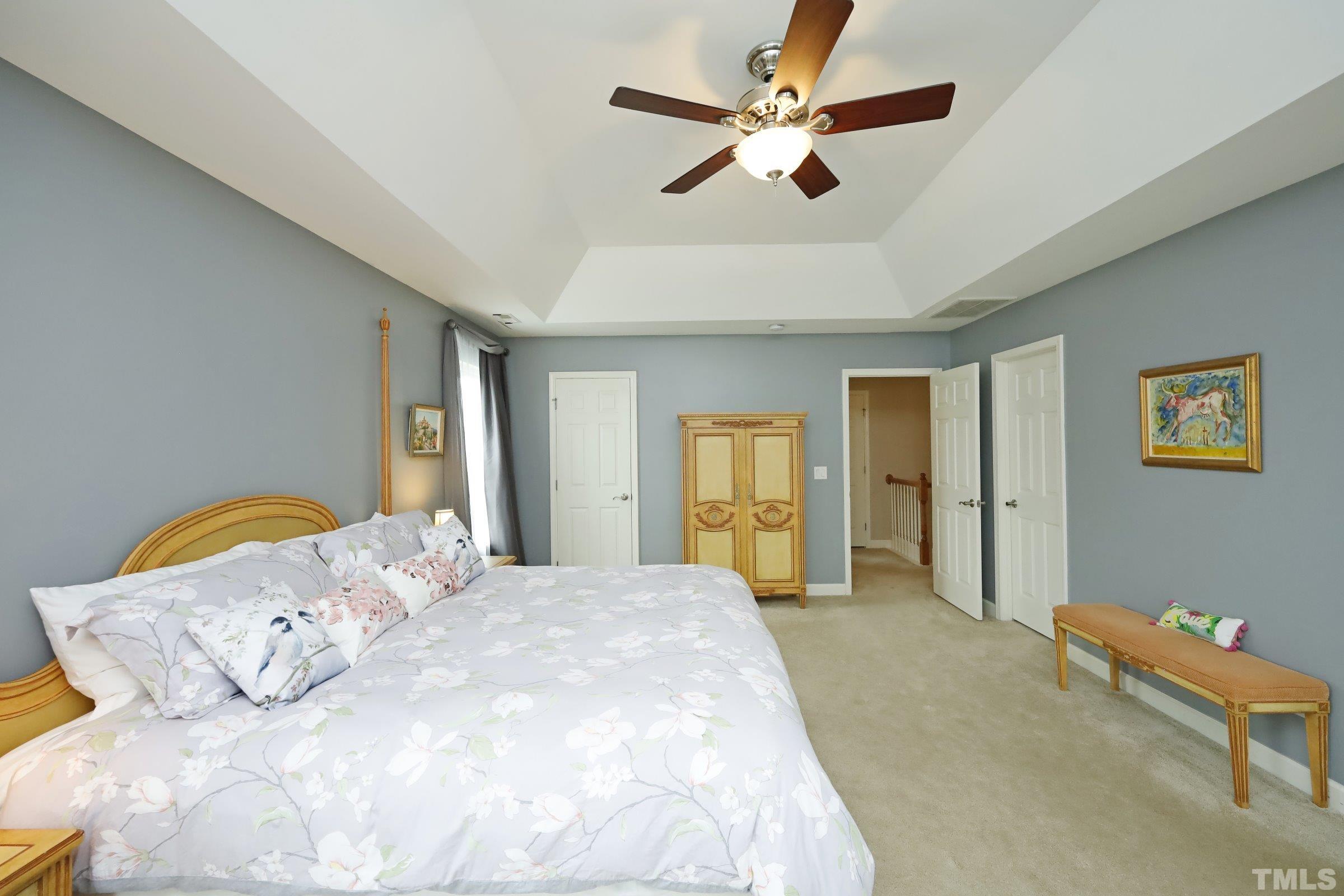 5325 Glass Ridge Road Raleigh, NC 27616 - Photo 23 of 42 a spacious bedroom with a bed a chandelier