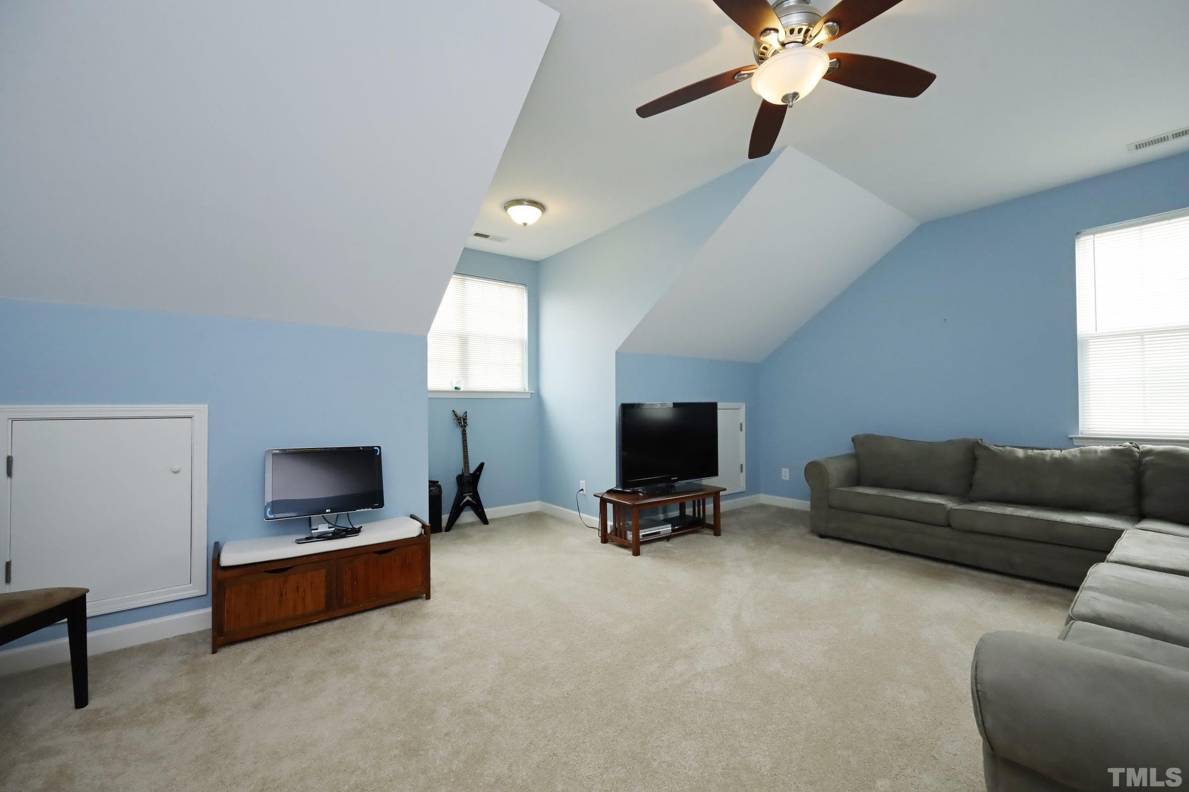 5325 Glass Ridge Road Raleigh, NC 27616 - Photo 28 of 42 a living room with furniture and a flat screen tv