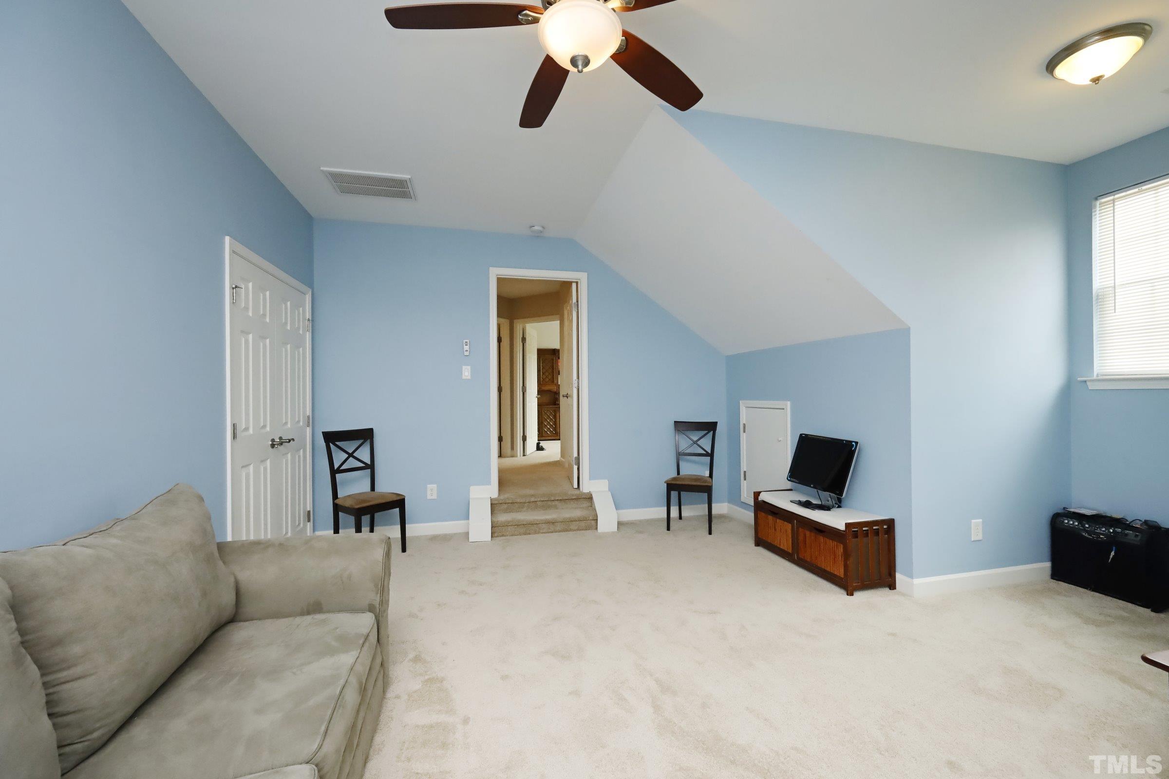 5325 Glass Ridge Road Raleigh, NC 27616 - Photo 29 of 42 a living room with furniture and a flat screen tv