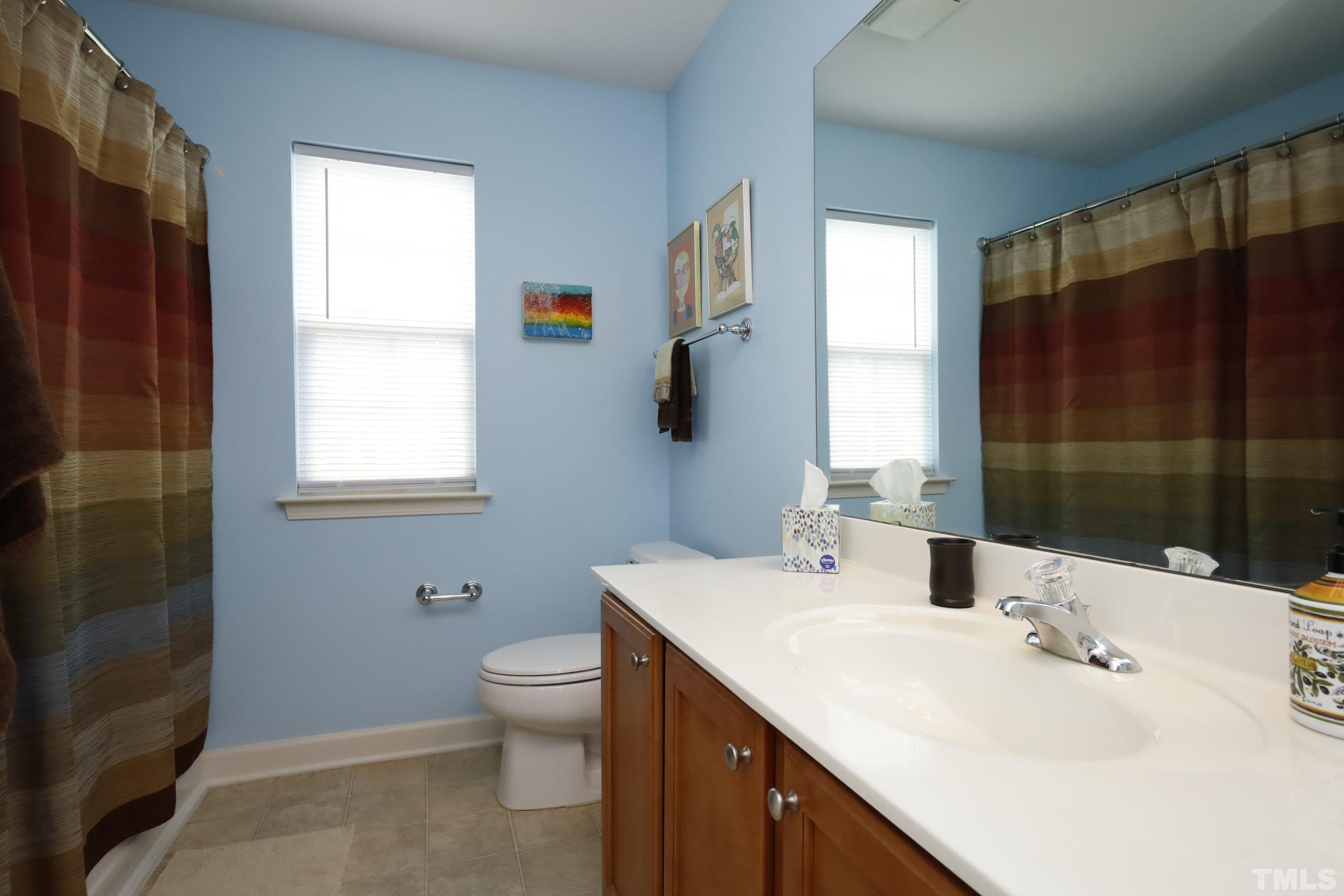 5325 Glass Ridge Road Raleigh, NC 27616 - Photo 30 of 42 a bathroom with a sink toilet and shower