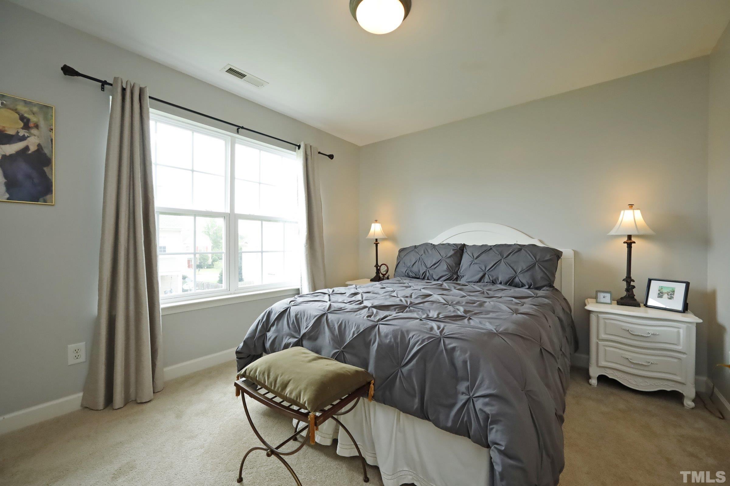 5325 Glass Ridge Road Raleigh, NC 27616 - Photo 31 of 42 a bedroom with a bed window and a chair