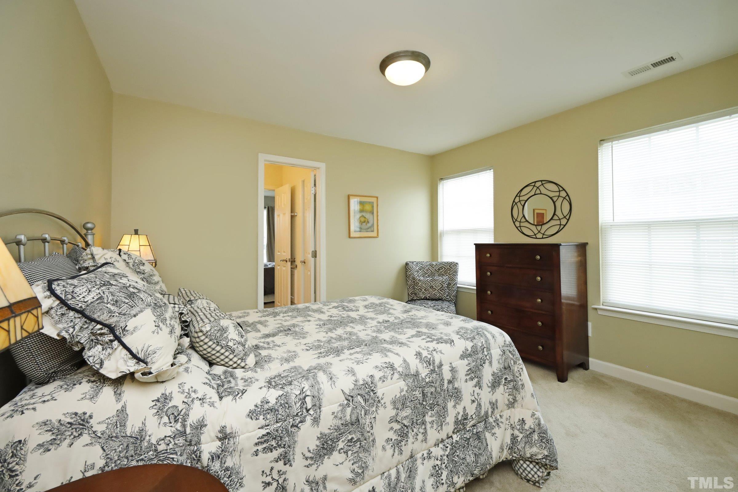 5325 Glass Ridge Road Raleigh, NC 27616 - Photo 32 of 42 a bedroom with a bed and dresser with mirror