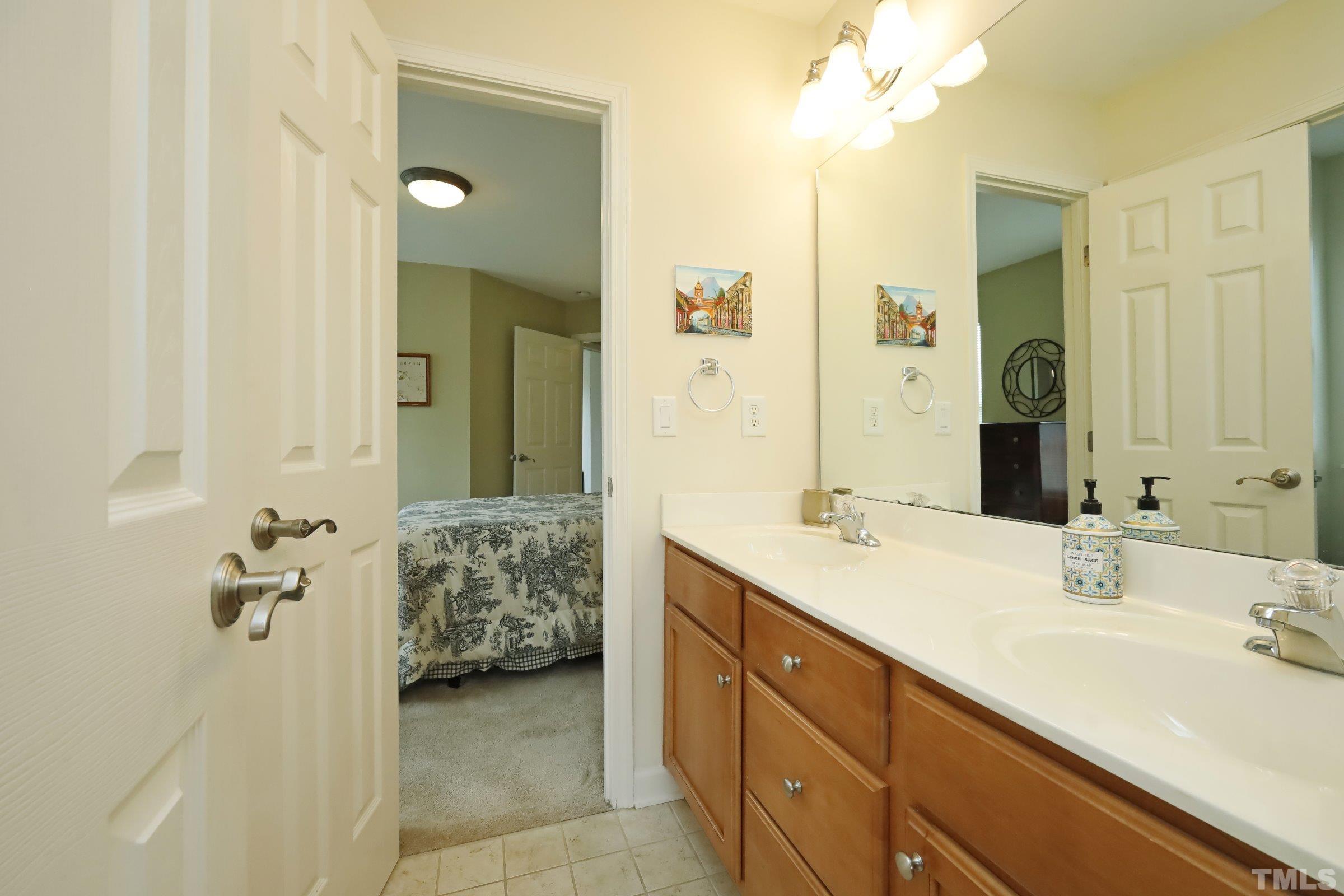 5325 Glass Ridge Road Raleigh, NC 27616 - Photo 34 of 42 a bathroom with a sink double vanity granite tub shower and a mirror