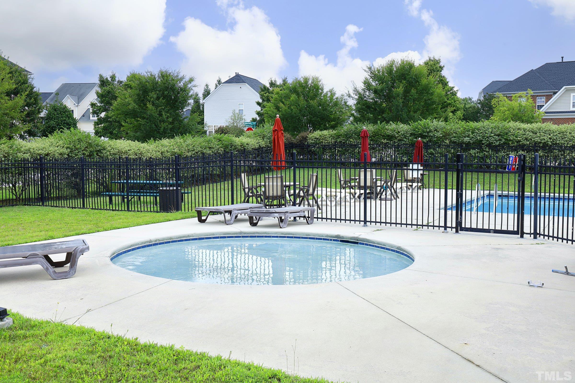 5325 Glass Ridge Road Raleigh, NC 27616 - Photo 40 of 42 a view of a backyard with a swimming pool and sitting area
