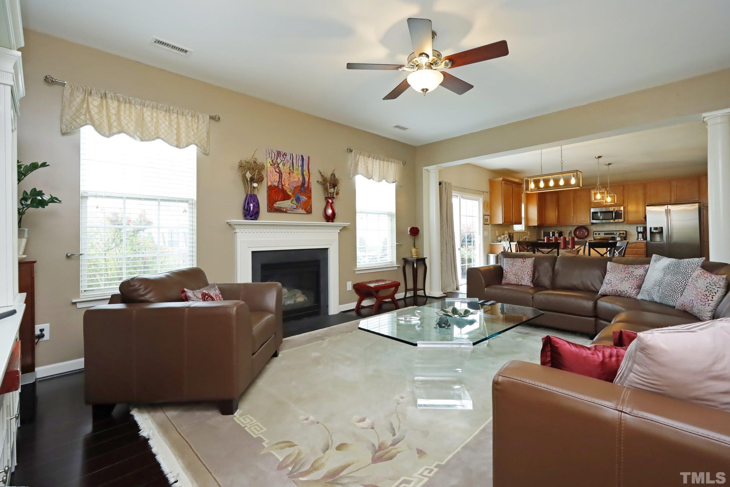 5325 Glass Ridge Road Raleigh, NC 27616 - Photo 9 of 42 a living room with furniture a fireplace and a large window